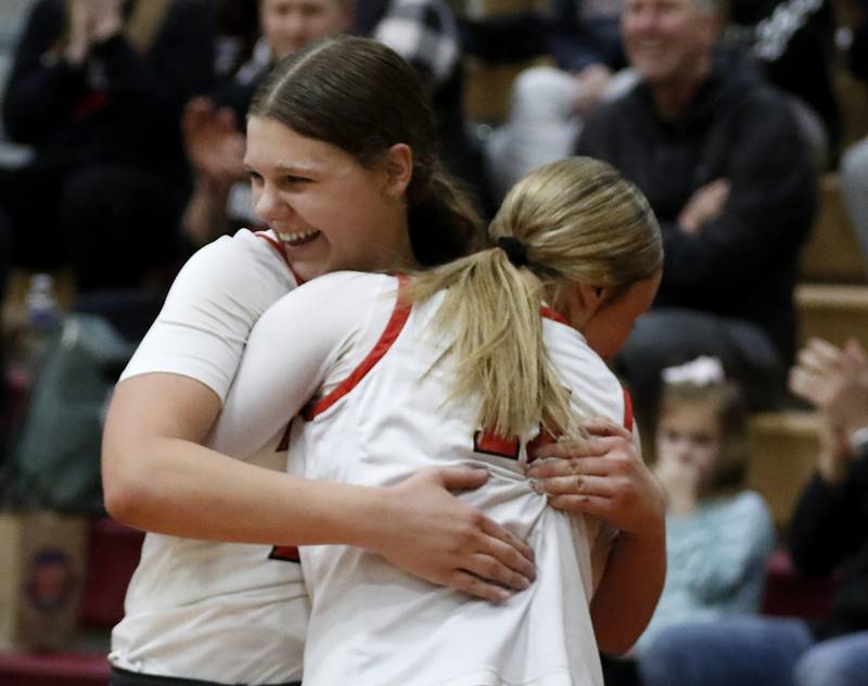 Huntley's Paula Strzelecki hugs her teammate, Anna Campanelli in the final minute of Huntley’s win over Libertyville in the IHSA Class 4A Huntley Sectional Championship girls basketball game on Thursday, Feb. 27, 2025, at Huntley High School.