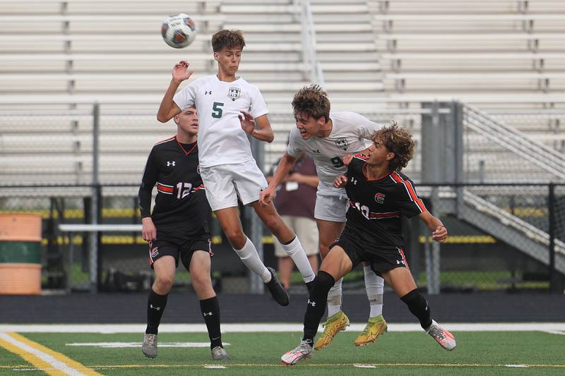 Plainfield Central’s Sean Thompson (5) and Gordon Stanich (9) head off the pass against Plainfield East on Tuesday, Sept. 19, in Plainfield.