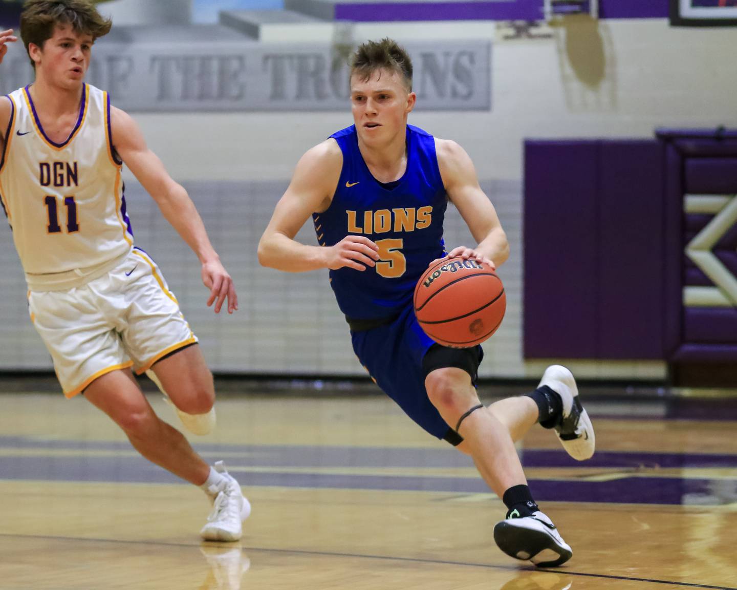 Lyon's Jackson Niego (5) advances the ball during varsity basketball game between Lyons at Downers Grove North.  Jan 31, 2023.