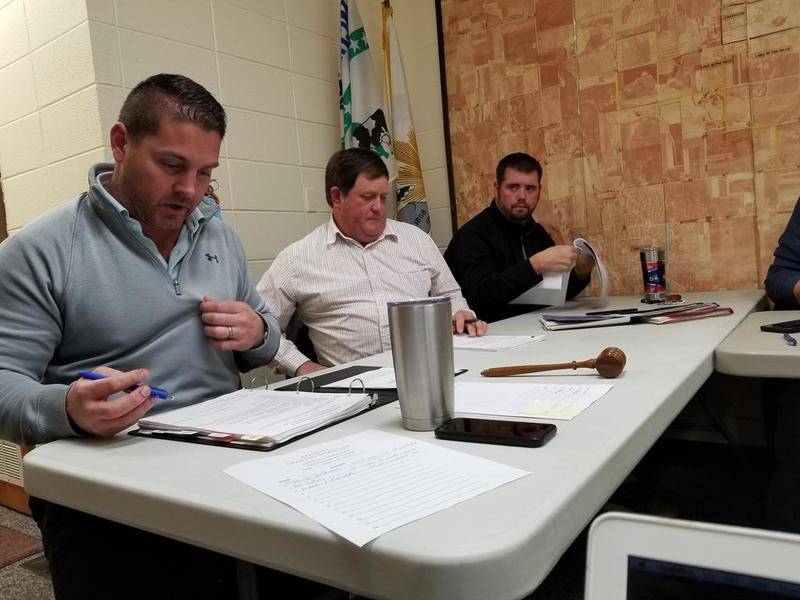 Grafton Township Supervisor Eric Ruth (from left), trustee Dan Ziller and trustee Sean Cratty go over township expenses during Monday's Board of Trustees meeting.