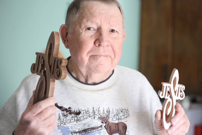 Bob Figurowski holds the same hand made crosses he brought to New York shortly after 9/11 to hand out. Thursday, Jan. 20, 2022 in Joliet.