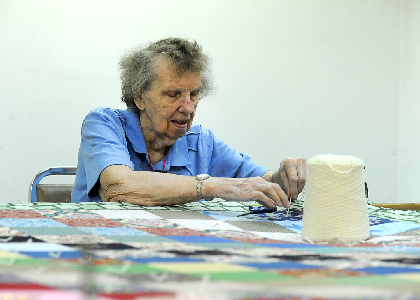 Maria Bremer stitches a quilt Wednesday, May 11, 2022, to send to Lutheran World Relief in the basement of Zion Evangelical Lutheran Church and School, 4206 W. Elm St. in McHenry. Since January, with the quilters now able to meet in person again, they have made 11 quilts for people in need.
