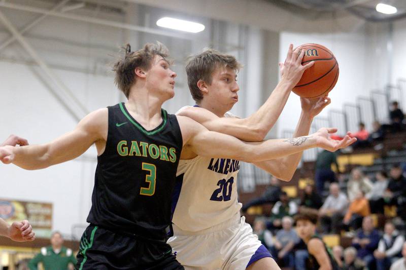 Crystal Lake South’s Colton Hess, left, and Lake Zurich’s Connor Strauss play in Hinkle Holiday Classic boys basketball tournament game action at Jacobs High School Wednesday.