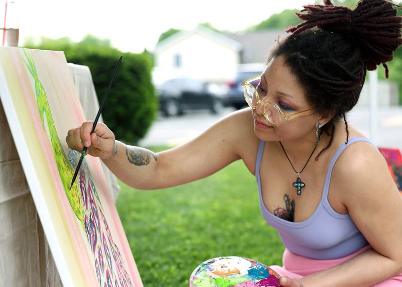 DeKalb artist Cheyenne Hoerr works on a painting during the Pride Palooza Friday, May 30, 2025, at Bethlehem Lutheran Church in DeKalb. The event was hosted by Family Service Agency of DeKalb County and Youth Outlook.