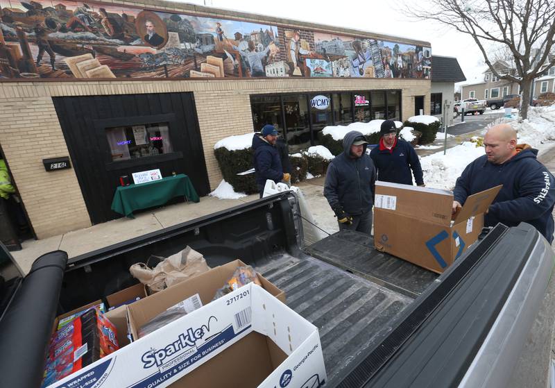 Ryan Nelle Traffic Manager at Infra-Metals in Marseilles, donates boxes of food during the 17th annual Freezin’ for a Reezin’ event on Friday, Dec. 5, 2025 outside of the WCMY studios downtown Ottawa. Donations support the Community Food Basket of Ottawa.