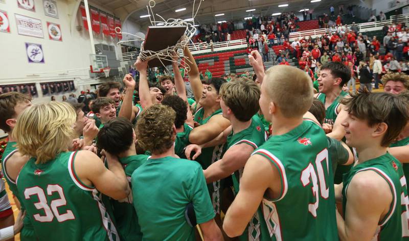 Members of the L-P boys basketball team hoist the Class 3A Regional title plaque after defeating Streator on Friday, Feb. 28, 2025 in Sellett Gymnasium at L-P High School.