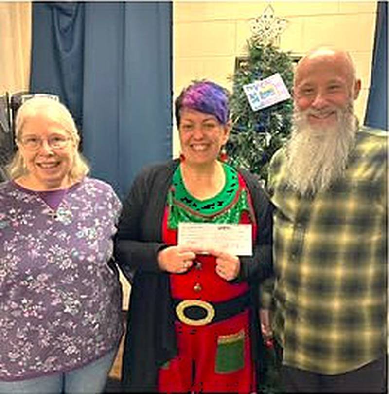 (From left) Pictured are Kathy Heikkinen from the Racial Development Committee, PADS Development Manager Jen Keller and Ed Manning from the committee. The committee donated a $2,106 check to Elgin PADS.