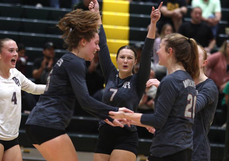 Prairie Ridge’s Addison Gertz, center, and the Wolves get revved up in their three-set loss  in varsity volleyball at Crystal Lake South Tuesday night.