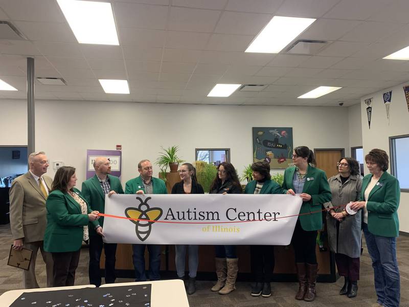 Representatives from the Autism Center of Illinois and Ottawa Chamber of Commerce pose for a photo during a ribbon-cutting ceremony last Friday, officially welcoming the center to Ottawa.