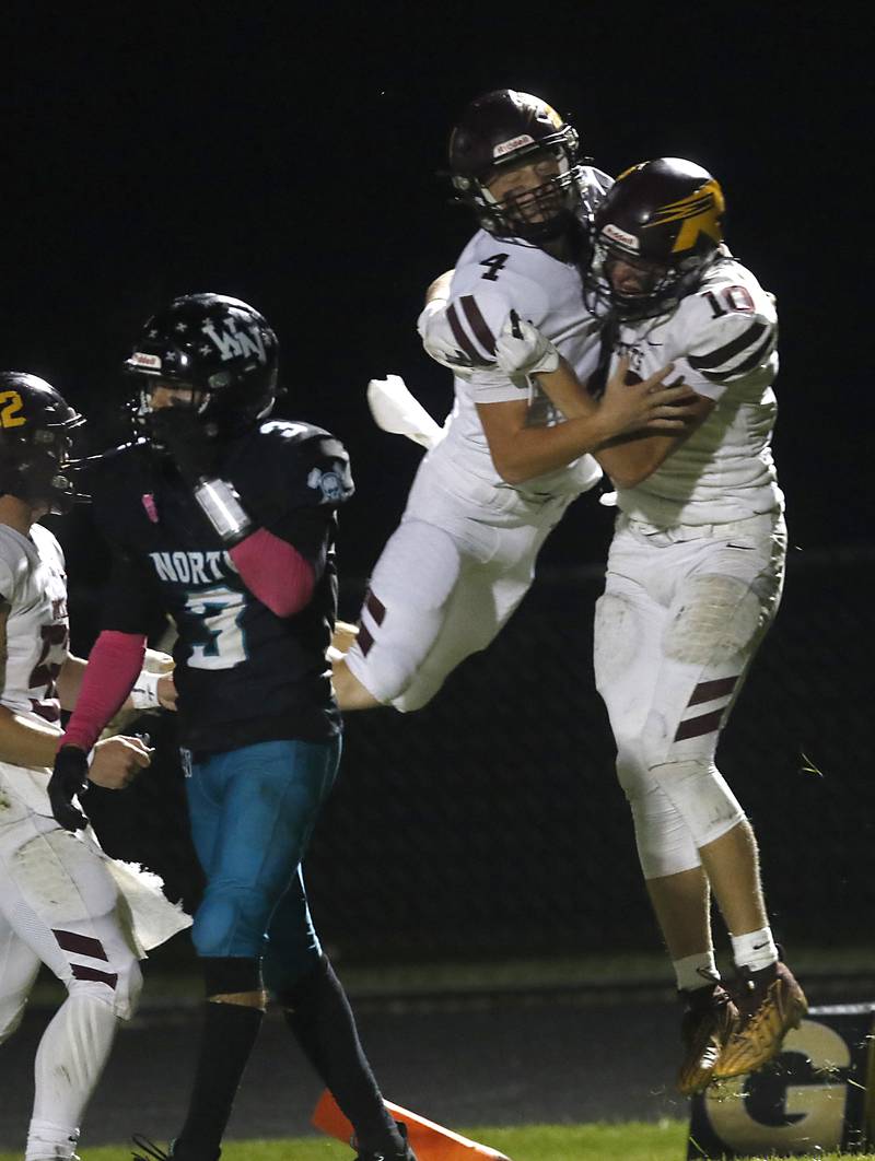 Richmond-Burton's Ray Hannemann jumps to congratulate his teammate, Luke Robinson, after Robinson caught Hannemann  pass for a touchdown against Woodstock North during a Kishwaukee River Conference football game on Friday, Oct. 10, 2025, at Woodstock North High School.