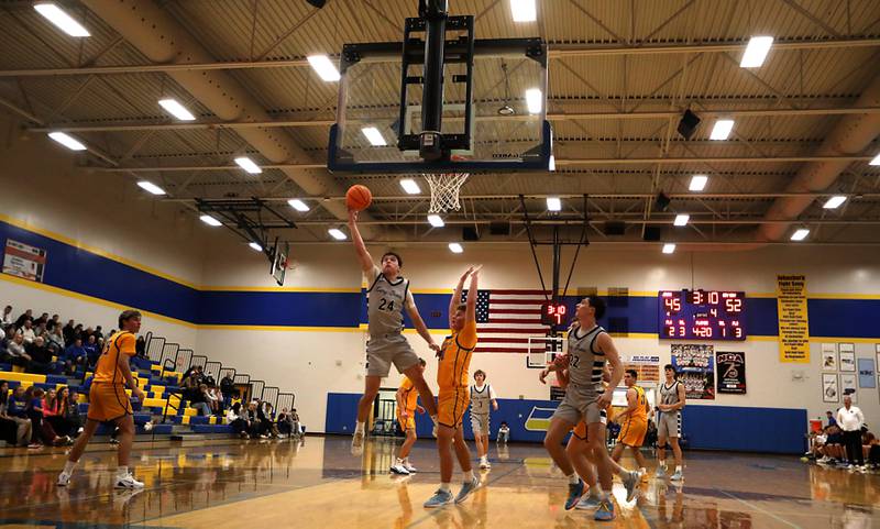 Cary-Grove's Brady Bauer drives to the basket against Johnsburg's Jayce Schmitt during a Johnsburg Thanksgiving Tournament boys basketball game on Monday, Nov. 24, 2025, at Johnsburg High School.