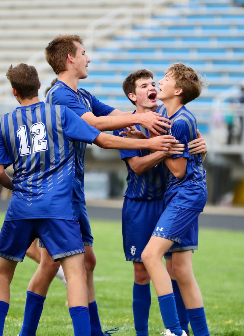 The Tigers celebrate a late penalty kick by Jackson Mason (right) to force a 4-4 draw against Kewanee Monday night at Bryant Field.