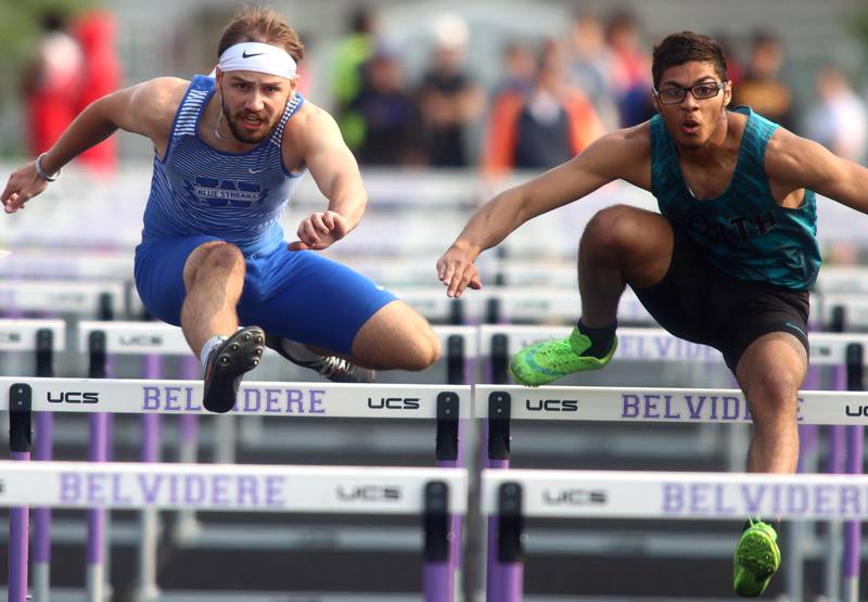 Woodstock’s Jared Kniola, left, and Woodstock North’s Giovanni Young complete the 110-meter hurdles during Class 2A Sectional track at Hugh K. Funderburg Stadium on the campus of Belvidere High School Wednesday, May 17, 2023.