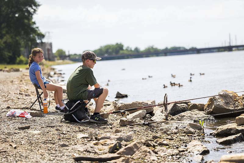 Gabby (left), 7, and Grady Staats, 14, of Sterling try a little fishing along the Rock River on Tuesday, July 2, 2024 at Seward’s Park in Rock Falls. With more rain expected, the National Weather Service issued a flood watch from 3 p.m. Tuesday until 2 a.m. Wednesday. Most of the threat is on the Mississippi River and toward the Quad-Cities.