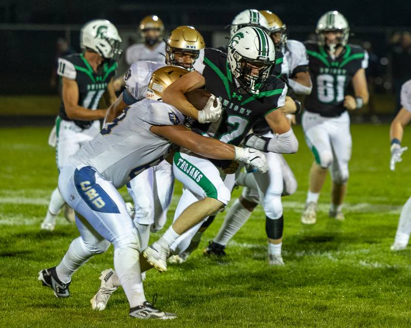 Alex Schaefer (68) of Marquette tackles Asher Kargle (12) of Dwight as he runs ball on Friday, Sept. 19, 2025 at Dwight High School in Dwight.
