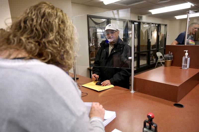 Amin Karim, (center) a Democrat candidate for McHenry County treasurer, files his candidate forms on Monday, Oct. 27, 2025, the first day of filling for the 2026 primary election, at the McHenry County Clerk's Office in Woodstock.