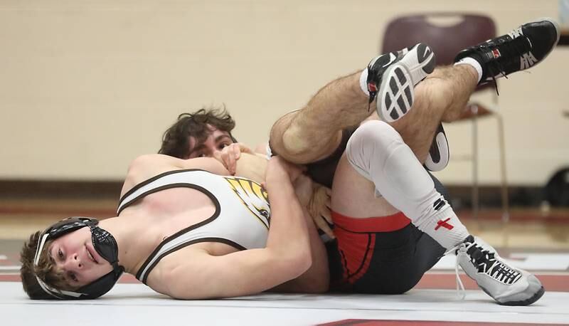 Huntley’s Collin Huminsky tries to pin Jacobs’ Adam Piazza during the 144—pound match of a Fox Valley Conference wrestling meet on Thursday, Dec. 11, 2025, at Huntley High School.