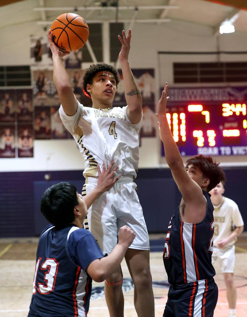 Hiawatha’s Elijah Beaver shoots between two DePue defenders during their game Tuesday, Jan. 20, 2026, at Hiawatha High School in Kirkland.
