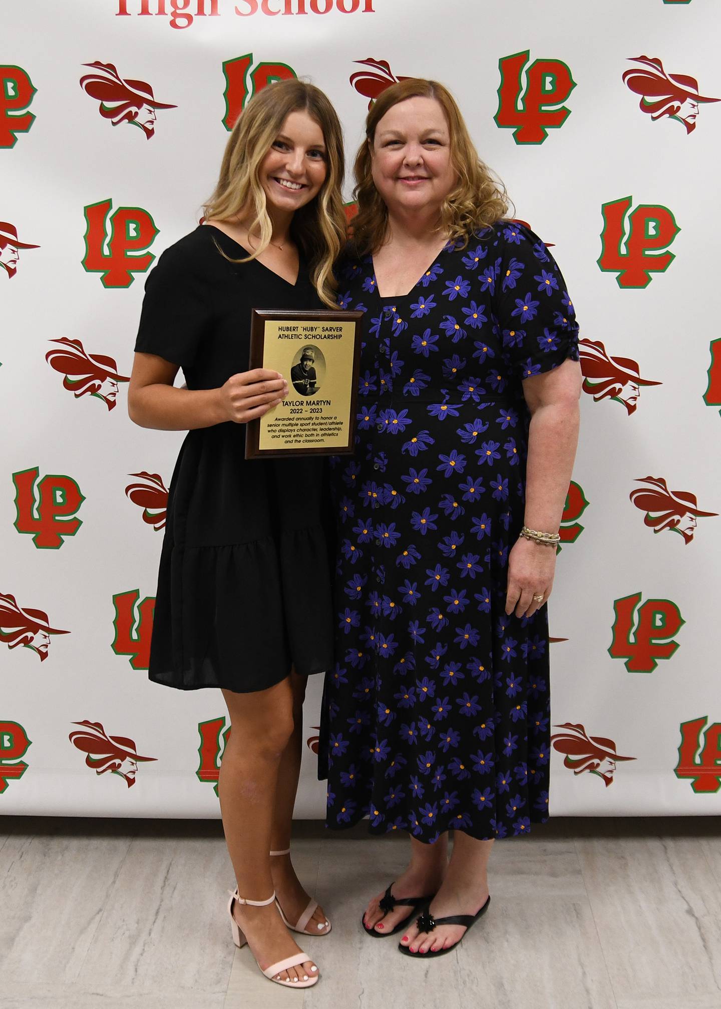 Taylor Martyn (left), a LaSalle-Peru Township High School senior, received the Hubert "Huby" Sarver Scholarship, presented by Kathy Eldridge. Named for former L-P coach Huby Sarver, the $1,000 scholarship is awarded by the Sarver family to an L-P student based on the student’s character, work ethic, leadership and multiple sport participation. Martyn will also have her name added to the plaque of past recipients.