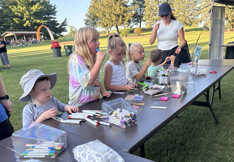 Kids create art at the Art in the Park table during the Oregon Park District's Concert in the Park on Tuesday, July 15, 2025 at Oregon Park West.