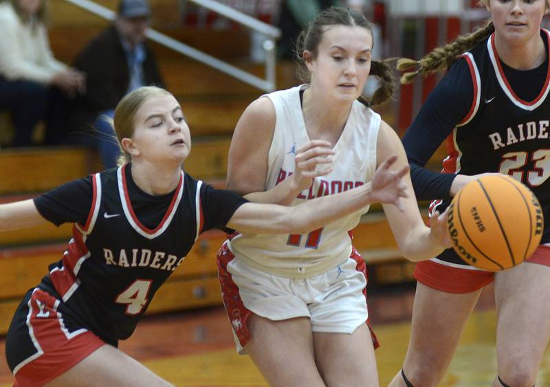 Earlville’s Jacey Helgesen (4) tries to knock the ball away from Streator’s Ava Gwaltney (11) Saturday morning in Streator.