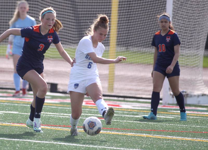 Geneva’s Luci Okolita (6) kicks the ball away from Oswego’s Gillian Young (3) during a Naperville Invitational game at Naperville Central on Saturday, April 23, 2022.