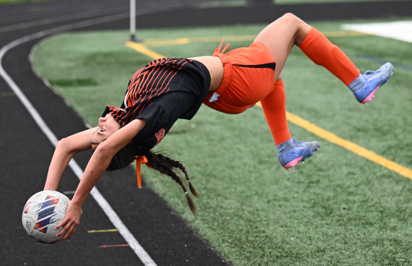 St. Charles East’s Mya Leon flips for a throw-in during the Saints’ Tri-Cities soccer night match against St. Charles North on Tuesday, May 5, 2026 in Batavia.