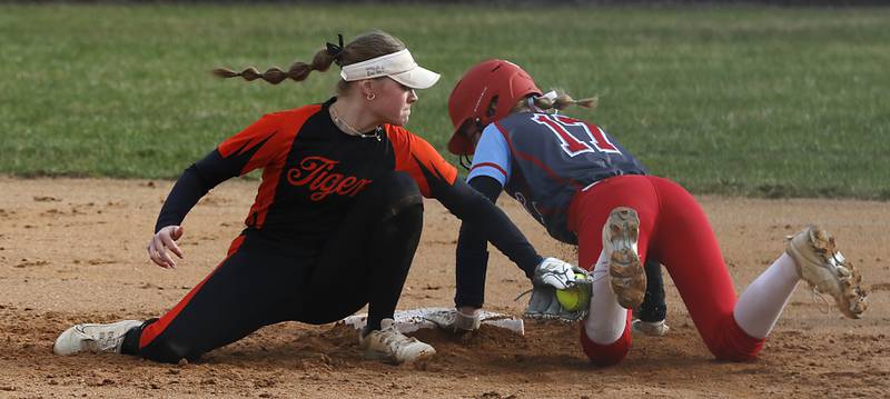 Crystal Lake Central's Kate Show tags Marian Central's Bailey Keller after she reached second base during a nonconference softball game on Thursday, April 3, 2025, at bates Park in Woodstock.