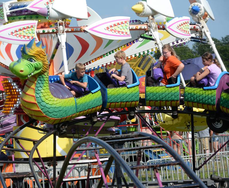 Kids ride the dragon rollercoaster at the Ogle County Fair on Friday, Aug. 2, 2024 west of Oregon.