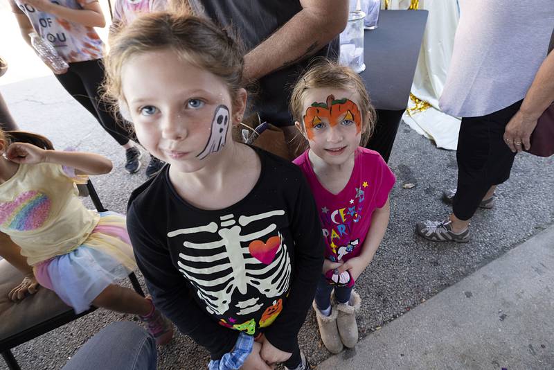Maddilyn, 8, and little sister Makaylie Sexton, 6, of Rock Falls show off their new art work Saturday, Oct. 22, 2022 during Dixon’s Scarecrow Fest.