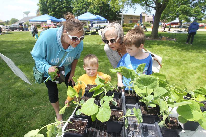 Jamie Andrekopoulos, of Third Lake, looks at vegetable plants with her children, Bode, 3, Tobin, 6, and Sue Polowy, of Long Grove, (Nana) Saturday, May 20, 2023, during the Lake County Extension Master Gardener Spring Plant Sale at the University of Illinois Extension in Grayslake.