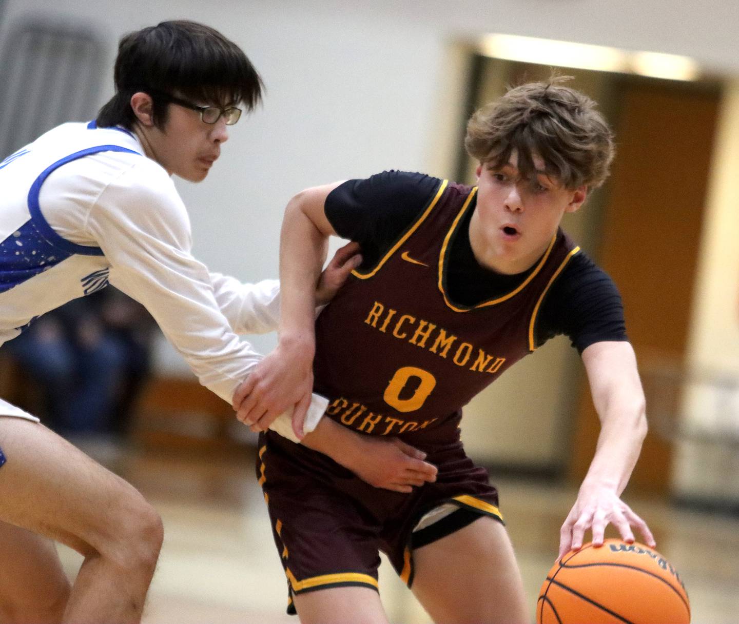 Richmond-Burton’s Gavin Radmer, right, works past Woodstock’s Joseph Nitz in varsity basketball on Wednesday, Dec. 18, 2024 at James M. Shipley Memorial Gymnasium on the campus of Woodstock High School in Woodstock.