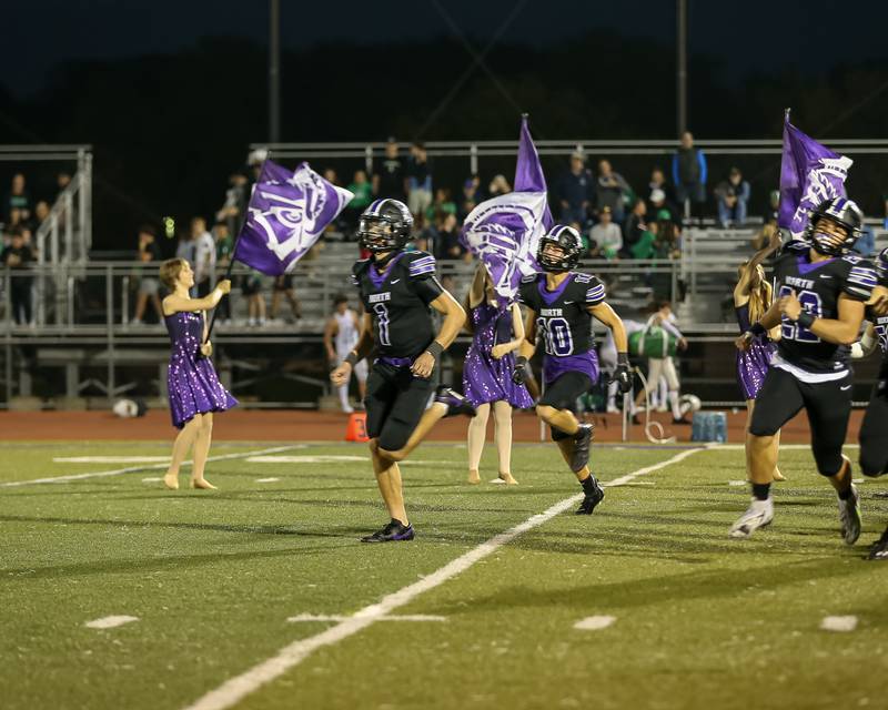 Downers Grove North's Damien Green (1) leads the team onto the field before football game between York at Downers Grove North.  Sept 29, 2023.