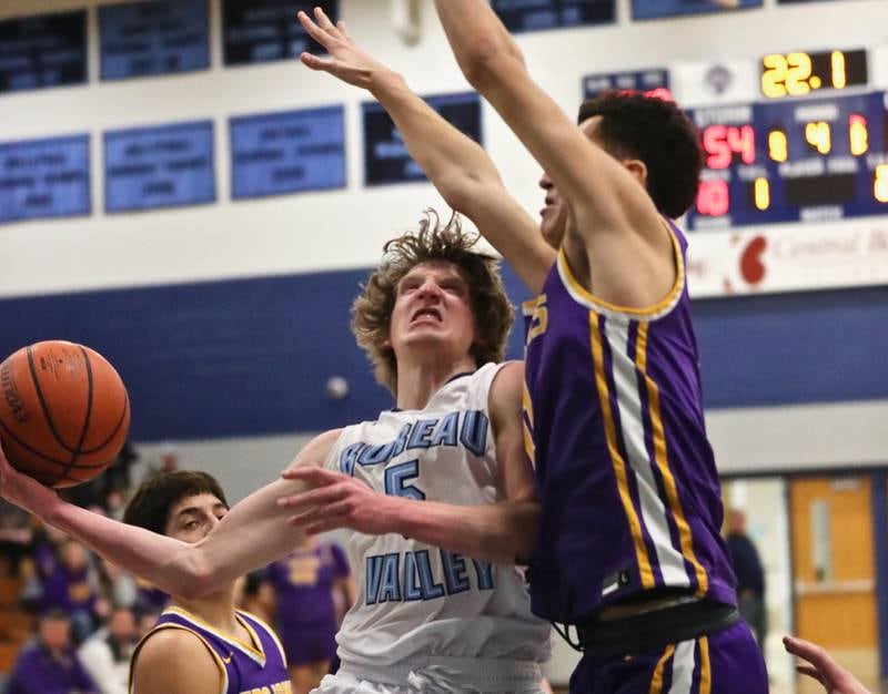 Bureau Valley's Carter Salisbury on Mendota's Rafa Romero in Saturday's Class 2A regional action at the Storm Cellar. The Trojans won 64-56.