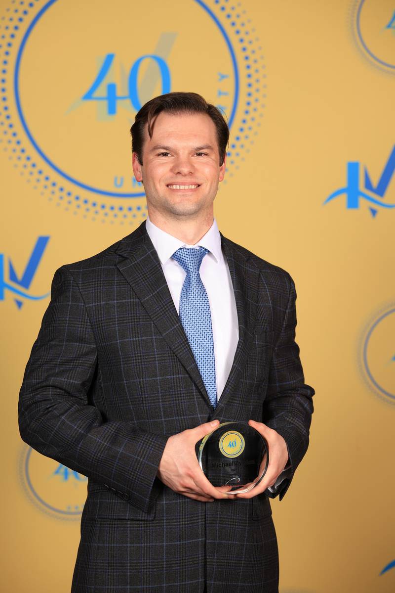Michael Zywica poses with his 40 Under Forty award during the Illinois Valley Chamber of Commerce Champions of Change Awards Night on Thursday, April 10, 2025 at the Westclox Event Center in Peru.
