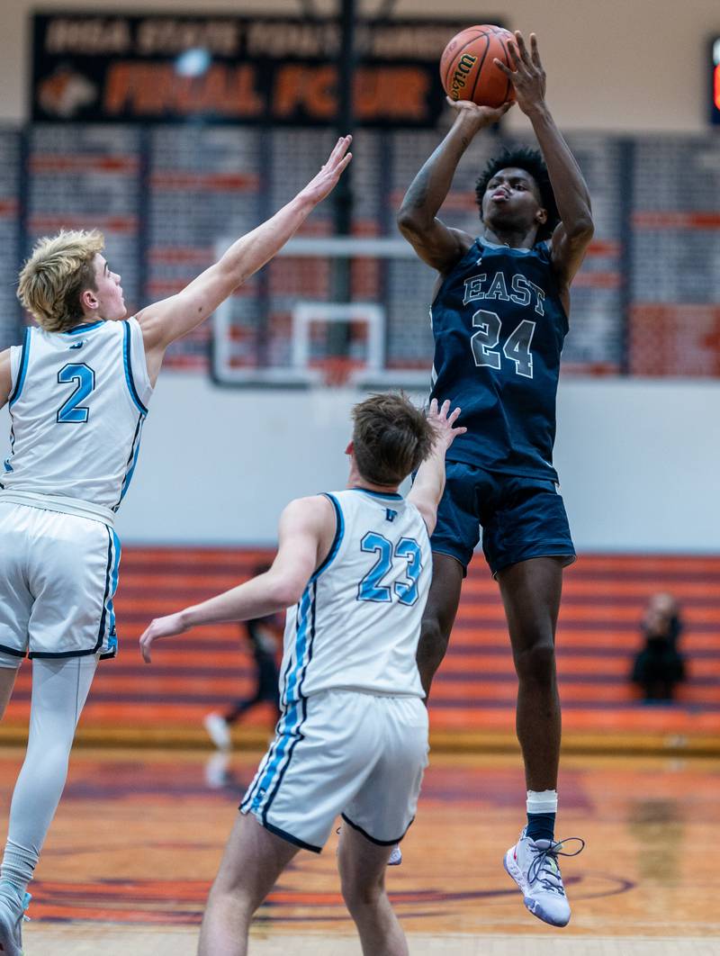 Oswego East's Mekhi Lowery (24) shoots the ball on the top of the key against Downers Grove South's during the hoops for healing basketball tournament at Naperville North High School on Monday, Nov 21, 2022.