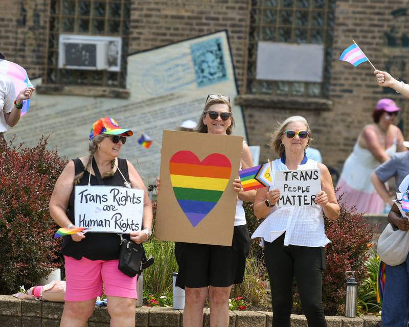 (From left) Jane Loomer, Joan Lanning and Candy Smith, all of Sycamore, hold signs in support of transgender people during a Trans Resilience Rally held on Sunday, June 22, 2025, in downtown DeKalb. Organizers said the rally was to show public support for people they believe are unjustly and harmfully targeted under President Donald Trump's policies.