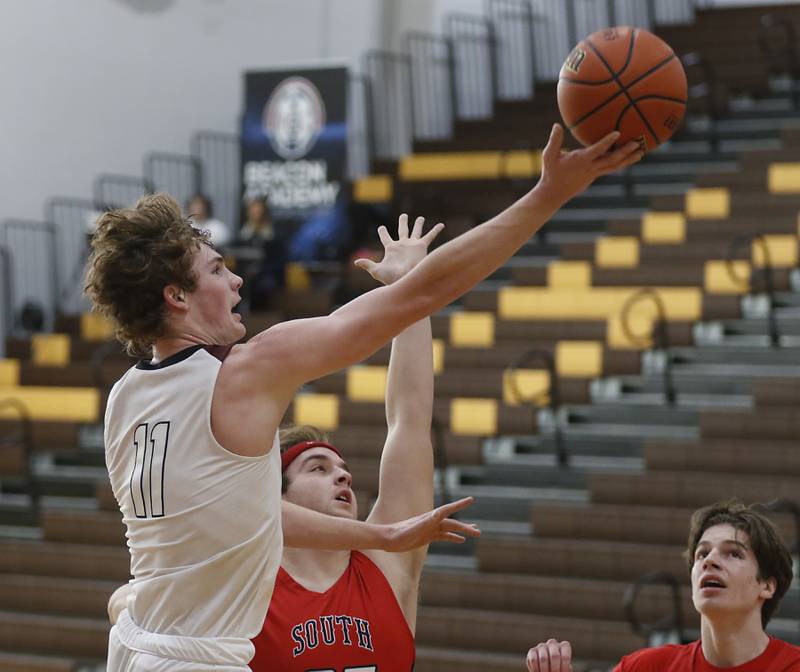 Prairie Ridge's James Muse drives to the basket against South Elgin’s Nathan Dinse during a Hinkle Holiday Classic basketball game Tuesday, Dec. 27, 2022, at Jacobs High School in Algonquin.