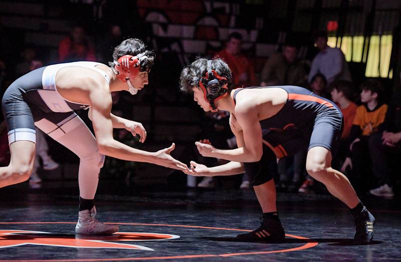 Marian Central's Andrew Alvarado and St. Charles East's Payton Lee wrestle at 132 pounds during a match in St. Charles on Wednesday, December 20, 2023.