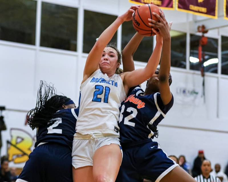Nazareth's Olivia Austin (21) comes down with a rebound during the Montini Christmas Classic, championship basketball game between Nazareth vs Young.  Dec 30, 2022.