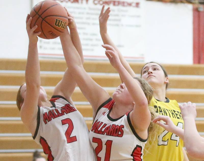 Henry-Senachwine's Brynna Anderson grabs a rebound with the help of teammate Brooklynn Thompson over Putnam County's Maggie Richetta on Monday, Dec. 18, 2023 in Henry.