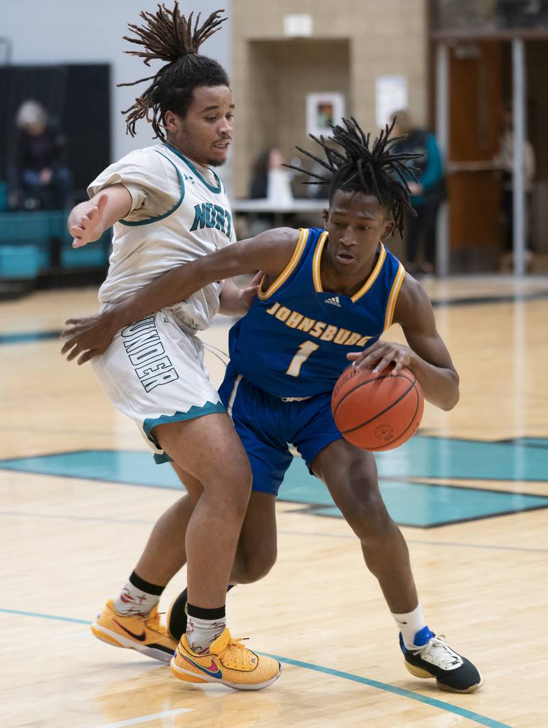 Johnsburg's Jarrel Albea pushes through Woodstock North defender Elijah White during their game on Wednesday, January 31, 2024 at Woodstock North High School. Ryan Rayburn for Shaw Local