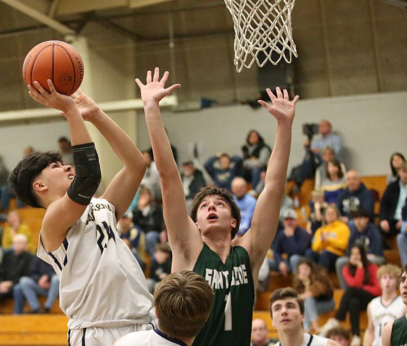 Marquette's Alex Graham posts up in the lane to score a bucket over St. Bede's Connor Brownin the Class 1A Regional semifinal on Wednesday, Feb. 22, 2023 at Midland High School.
