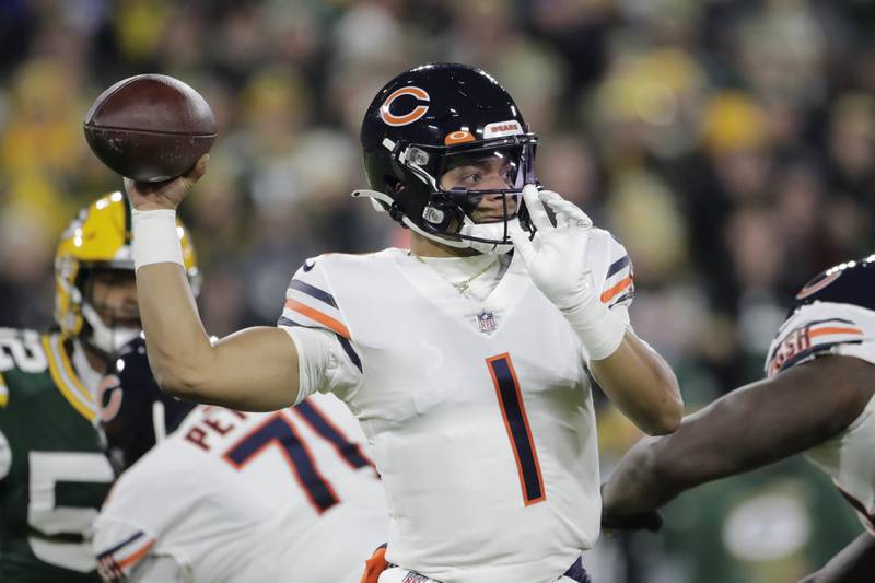 Chicago Bears' Justin Fields throws during the first half against the Green Bay Packers Sunday, Dec. 12, 2021, in Green Bay, Wis.
