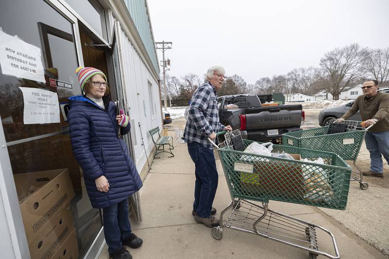Dixon Food Pantry volunteers Peggy Carlson, Gary Steder and Steve Grace work the line of cars Monday, Jan. 29, 2024 at the pantry. The pantry is open Monday, Wednesday and Friday from 1-3 pm.