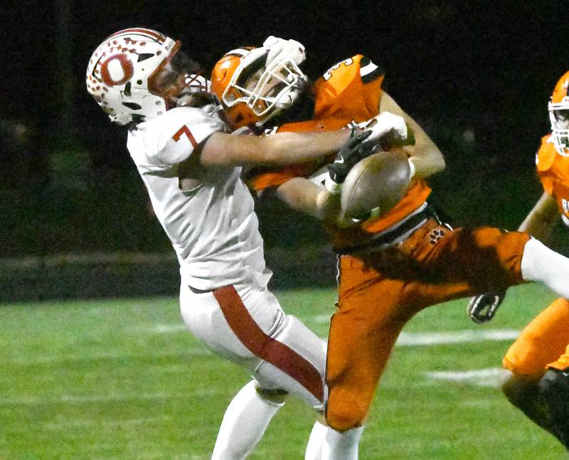 Oregon's Ethan Peeling (7) and Byron's Landon Bonvallet (34) battle for the ball during 3A football playoff action on Friday, Oct. 31, 2025 at the Everett Stine Stadium in Byron.