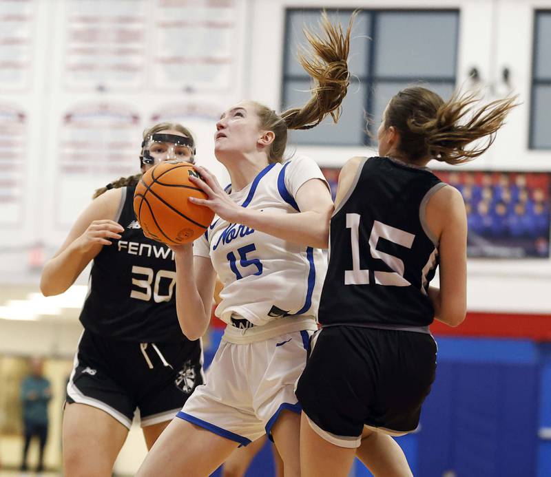 St. Charles North's Bronwyn How (15) slides between Fenwick's Claire Murphy (30) and Cammie Molis (15) during the Dundee-Crown High School 41st Annual Komaromy Classic Friday, Dec. 27, 2024 in Carpentersville.