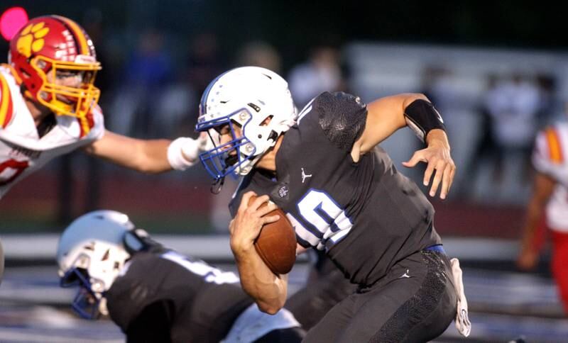 St. Charles North quarterback Ethan Plumb keeps the ball during a home game against Batavia on Friday, Sept. 15, 2023.