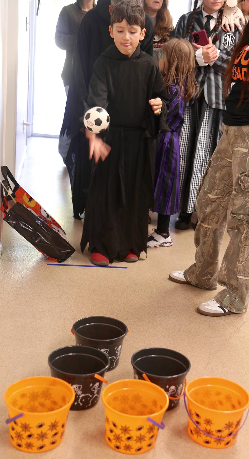 Killiam Woods, 9, plays one of the many carnival games at the Fox Valley Family YMCA West branch Trick or Trunk on Sunday, Oct. 26, 2025 in Sandwich.