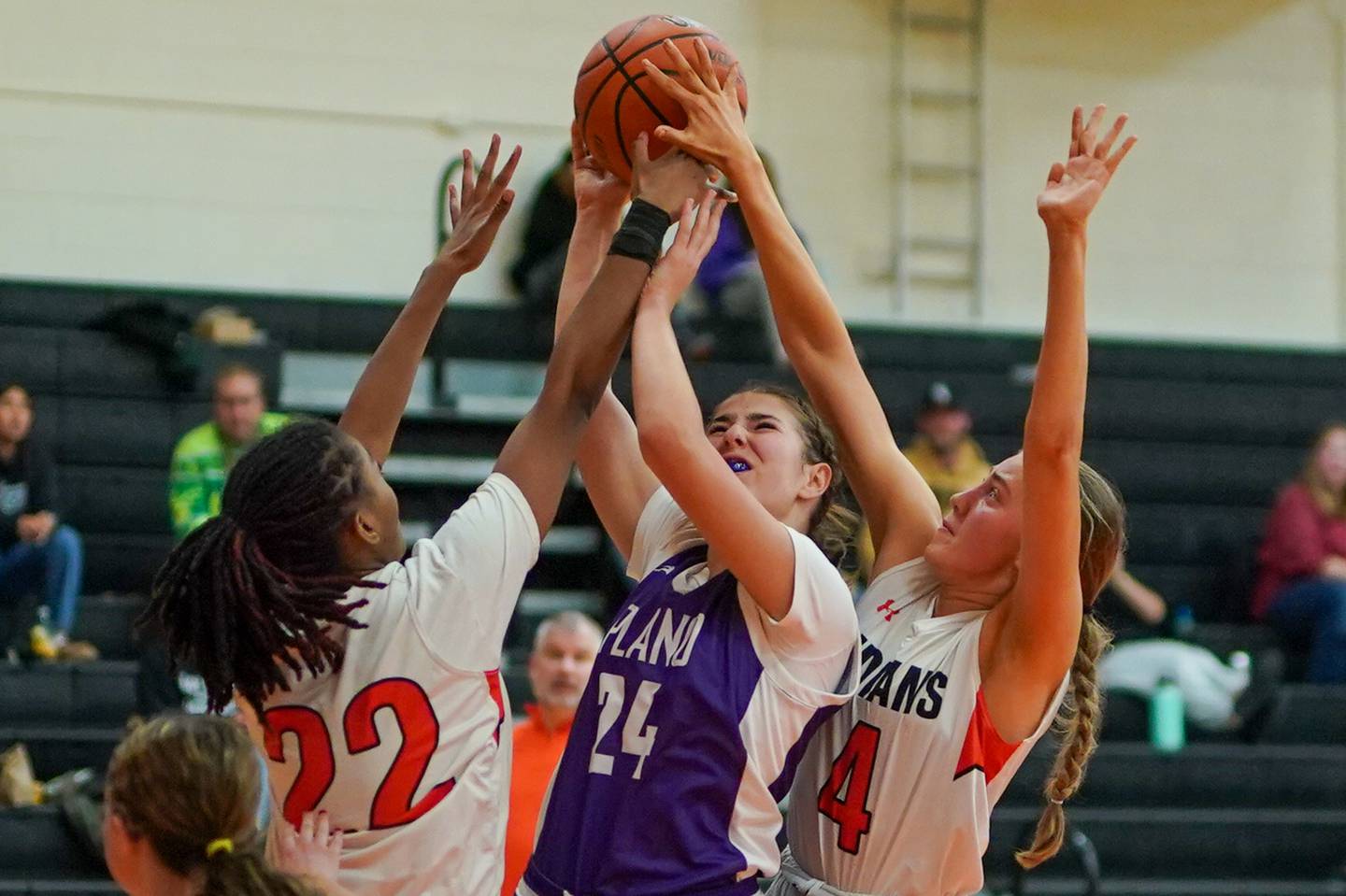 Sandwich’s Alayla Harris (22) and Hanna Treptow (4) defend the paint against Plano's Chloe Rowe (24) during a basketball game at Sandwich High School on Tuesday, Dec. 3, 2024.